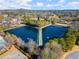 A lovely aerial view of an expansive community pond with a water feature at 6170 Wellington Ct, Cumming, GA 30040