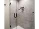 Stylish shower with glass doors, tiled walls, and a convenient built-in niche at 6170 Wellington Ct, Cumming, GA 30040