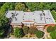 Gray flat roof with multiple units, with manicured green bushes surrounding a brick building at 978 North Ne Ave # 307, Atlanta, GA 30306