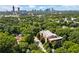 Beautiful aerial view of a brick building surrounded by lush green trees with Atlanta skyline at 978 North Ne Ave # 307, Atlanta, GA 30306