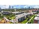 Aerial neighborhood view with contemporary apartment buildings, trees, and city skyline at 978 North Ne Ave # 307, Atlanta, GA 30306