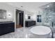 Luxurious bathroom featuring dual vanities, a soaking tub, and a glass-enclosed shower at 4132 Carmain Ne Dr, Atlanta, GA 30342