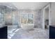 Elegant bathroom showcasing a freestanding tub, glass shower, and marble tile throughout at 4132 Carmain Ne Dr, Atlanta, GA 30342