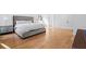 Spacious bedroom with hardwood floors, a stylish grey bed frame, and a well-lit ambiance at 4132 Carmain Ne Dr, Atlanta, GA 30342