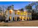 Charming two-story home with a symmetrical facade, warm exterior lighting, and a well-manicured front lawn at 4132 Carmain Ne Dr, Atlanta, GA 30342
