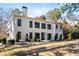 Beautiful two-story home boasting a modern design, black-framed windows, and a lush green front yard at 4132 Carmain Ne Dr, Atlanta, GA 30342