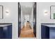 Hallway with dark trim, hardwood floors, and a view of a fireplace in the distance at 4132 Carmain Ne Dr, Atlanta, GA 30342