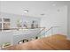 Hallway featuring hardwood floors, glass railings and a view of surrounding trees at 4132 Carmain Ne Dr, Atlanta, GA 30342