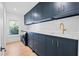 Stylish laundry room with custom cabinets, quartz countertops, and modern appliances at 4132 Carmain Ne Dr, Atlanta, GA 30342