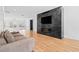 Living room boasts a modern fireplace, hardwood floors, and open layout to the second floor at 4132 Carmain Ne Dr, Atlanta, GA 30342