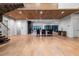 Open-concept living area with hardwood floors, wood ceiling, modern staircase, and floor-to-ceiling windows at 4132 Carmain Ne Dr, Atlanta, GA 30342