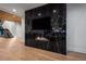 Modern living room showcasing a black marble wall with a fireplace and hardwood floors at 4132 Carmain Ne Dr, Atlanta, GA 30342
