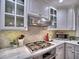 Updated kitchen boasts stainless steel appliances, ample counter space and designer backsplash at 5660 Colton Dr, Atlanta, GA 30342