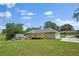 A large backyard with a deck, a storage shed, an outbuilding, and surrounded by mature trees at 9035 Teal Ln, Jonesboro, GA 30236