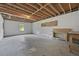 Unfinished basement area with exposed ceiling, concrete floor, block walls, and work bench at 9035 Teal Ln, Jonesboro, GA 30236