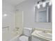 Functional bathroom with a shower, toilet, and vanity with modern fixtures and lighting at 9035 Teal Ln, Jonesboro, GA 30236
