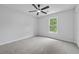 Bright bedroom with soft carpet, a ceiling fan, and a large window with scenic views at 9035 Teal Ln, Jonesboro, GA 30236