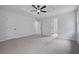 Expansive bedroom featuring plush carpet, a modern ceiling fan, and multiple entryways at 9035 Teal Ln, Jonesboro, GA 30236