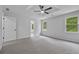 Bright bedroom with neutral carpet, a ceiling fan, and an ensuite bathroom entrance at 9035 Teal Ln, Jonesboro, GA 30236