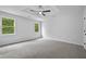 Spacious bedroom with large windows providing natural light and a ceiling fan for comfort at 9035 Teal Ln, Jonesboro, GA 30236