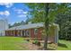 Brick home with a side view featuring a tree in the front yard and a well-maintained lawn at 9035 Teal Ln, Jonesboro, GA 30236