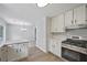 Updated kitchen with white cabinets, quartz countertops, and stainless steel appliances at 9035 Teal Ln, Jonesboro, GA 30236