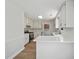 Modern kitchen featuring white cabinets, stone countertops, stainless steel appliances, and wood-look floors at 9035 Teal Ln, Jonesboro, GA 30236
