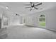 Open living room featuring neutral carpet, a fireplace, and lots of natural light from the windows at 9035 Teal Ln, Jonesboro, GA 30236