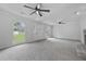 Bright living room with neutral carpet, a fireplace, and views of the front yard at 9035 Teal Ln, Jonesboro, GA 30236