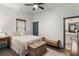 Neutral bedroom features a ceiling fan, area rug, bench, and view into the attached bath at 1171 Eggleston Sw St, Atlanta, GA 30310