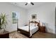 Bedroom with hard wood flooring, ceiling fan, and large bright window at 1171 Eggleston Sw St, Atlanta, GA 30310