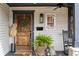 Cozy porch with stained wood door, greenery, and classic West End signage at 1171 Eggleston Sw St, Atlanta, GA 30310