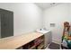 A clean laundry room featuring a folding table and modern washer and dryer at 1171 Eggleston Sw St, Atlanta, GA 30310