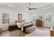 Bright main bedroom with large windows, tray ceiling, and a ceiling fan at 1171 Eggleston Sw St, Atlanta, GA 30310