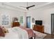 Bright main bedroom with tray ceiling, ceiling fan, and an exterior door to access the back yard at 1171 Eggleston Sw St, Atlanta, GA 30310