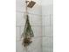 Close up of shower with marble tile and bronze shower head at 1171 Eggleston Sw St, Atlanta, GA 30310