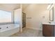 Elegant bathroom showcasing a glass shower, sleek vanity, and tub at 5669 Casa Blanca Ln, Atlanta, GA 30331