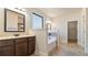 Bright bathroom featuring double vanity, soaking tub, and natural light from a large window at 5669 Casa Blanca Ln, Atlanta, GA 30331