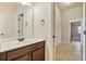 Bathroom features a vanity with a dark wood cabinet, white countertop, and tile flooring leading to additional rooms at 5669 Casa Blanca Ln, Atlanta, GA 30331