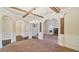 Empty dining room featuring an arched entryway and coffered ceiling at 5669 Casa Blanca Ln, Atlanta, GA 30331