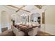 Elegant dining room featuring an arched entryway, coffered ceiling, and ample seating at 5669 Casa Blanca Ln, Atlanta, GA 30331