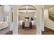 Elegant dining room featuring an arched entryway, coffered ceiling, and ample seating at 5669 Casa Blanca Ln, Atlanta, GA 30331