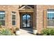 Close-up of the home's front entrance featuring a decorative glass door and manicured plants at 5669 Casa Blanca Ln, Atlanta, GA 30331