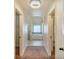 Well-lit hallway with doorways leading to the rooms with neutral paint scheme and decorative lighting fixture at 5669 Casa Blanca Ln, Atlanta, GA 30331