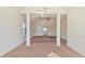 Spacious living room featuring carpeted floors, a ceiling fan, and classic white trim at 5669 Casa Blanca Ln, Atlanta, GA 30331