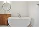 Bright bathroom featuring white walls, a modern soaking tub, and wooden cabinets at 675 Drewry Ne St # 201, Atlanta, GA 30306