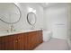 Bright bathroom featuring a double vanity, round mirrors, and a modern soaking tub at 675 Drewry Ne St # 201, Atlanta, GA 30306