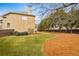 A full view of the landscaped backyard with mature trees and a privacy fence at 2953 Kings Walk Ave, Marietta, GA 30062