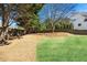 Backyard featuring a mix of grassy lawn and mulched areas, surrounded by a wooden fence at 2953 Kings Walk Ave, Marietta, GA 30062