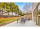 View of backyard featuring a table and seating on a concrete patio with a brick retaining wall at 2953 Kings Walk Ave, Marietta, GA 30062